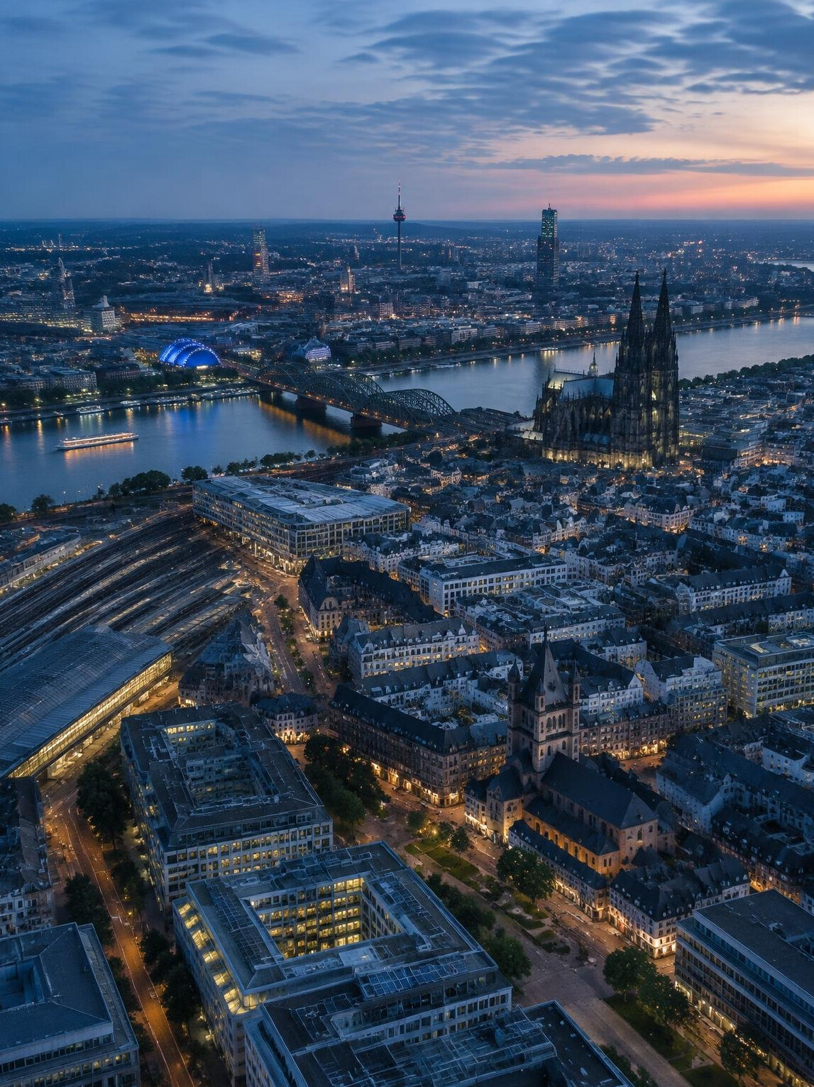 Aerial view of a modern city with buildings and streets at dusk